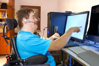 Young man with downs syndrome working with computer