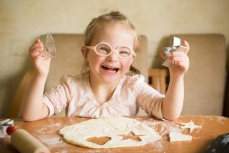 Girl with Down's syndrome baking cookies